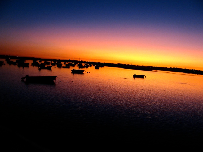 harbor at sunset in faro, portugal